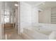 Bright bathroom featuring a soaking tub, an oversized mirror, and wood cabinets at 3726 Las Vegas Blvd # 704, Las Vegas, NV 89158