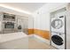 Modern kitchen featuring stainless steel appliances and a stacked washer and dryer unit at 3726 Las Vegas Blvd # 704, Las Vegas, NV 89158