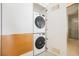 A compact laundry area featuring stacked washer and dryer units, designed for efficiency and convenience in a modern home at 3726 Las Vegas Blvd # 704, Las Vegas, NV 89158