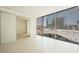 A bright and spacious living room with large windows showcasing city views and a sliding glass door to an adjoining room at 3726 Las Vegas Blvd # 704, Las Vegas, NV 89158
