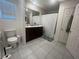Bright bathroom with double vanity, tile flooring, and shower-tub combo for a spa-like experience at 4056 Campeche Ave, Las Vegas, NV 89121