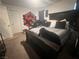 Bedroom with dark-wood bed frame, carpet floors, and natural light provides a comfortable personal space at 4056 Campeche Ave, Las Vegas, NV 89121