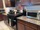 Well-equipped kitchen featuring granite countertops and stainless steel appliances provides ample cooking space at 4056 Campeche Ave, Las Vegas, NV 89121