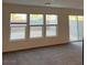 Bright living room with large windows and sliding glass door, offering natural light at 4056 Campeche Ave, Las Vegas, NV 89121