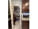Pantry with multiple shelves for ample storage next to cabinets with granite countertops at 4056 Campeche Ave, Las Vegas, NV 89121