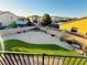 View of the backyard featuring a gravel area, artificial turf and a brick fence around the perimeter at 4076 Topaz Hills Dr, North Las Vegas, NV 89032