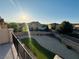 An elevated view of a private backyard featuring artificial grass, desert landscaping, and privacy walls at 4076 Topaz Hills Dr, North Las Vegas, NV 89032
