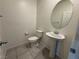 Cozy half bathroom features a pedestal sink and tile flooring at 4076 Topaz Hills Dr, North Las Vegas, NV 89032