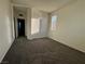 A carpeted bedroom with a window, closet and a doorway with an open door within the room at 4076 Topaz Hills Dr, North Las Vegas, NV 89032