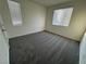 This bedroom has plush carpet and is brightly lit by two windows at 4076 Topaz Hills Dr, North Las Vegas, NV 89032