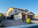 Two-story home boasting a large brick paved driveway and secure gated side entrance at 4076 Topaz Hills Dr, North Las Vegas, NV 89032