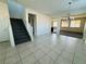 Bright foyer with tile flooring, a staircase, and an open view to the living spaces at 4076 Topaz Hills Dr, North Las Vegas, NV 89032