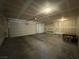 Spacious two-car garage with lighting, drywall, and two garage doors with a small table at 4076 Topaz Hills Dr, North Las Vegas, NV 89032