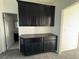 Hallway includes black cabinets with countertop along with doorways to other rooms within the home at 4076 Topaz Hills Dr, North Las Vegas, NV 89032