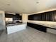 Modern kitchen with black cabinetry, a white center island, and stainless steel appliances at 4076 Topaz Hills Dr, North Las Vegas, NV 89032