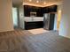 Kitchenette area includes dark wood cabinets and stainless steel refrigerator at 4076 Topaz Hills Dr, North Las Vegas, NV 89032