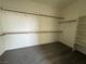 A spacious walk-in closet with ample shelving for organization and storage with grey carpeting at 4076 Topaz Hills Dr, North Las Vegas, NV 89032