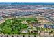 Aerial view of community park with green grass, walking trails, playground, and manicured landscaping at 412 Gracious Way, Henderson, NV 89011