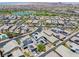 Stunning aerial view of neighborhood homes complete with solar panels, lush landscaping and a community lake and walking trails at 412 Gracious Way, Henderson, NV 89011