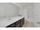 Clean bathroom with dark vanity, white countertop and shower-tub combo at 412 Gracious Way, Henderson, NV 89011
