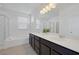 Modern bathroom boasts a double sink vanity, generous counter space, tub, and glass-enclosed shower at 412 Gracious Way, Henderson, NV 89011