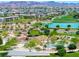 Aerial view of community park with lake, playground, walking trails and mature trees at 412 Gracious Way, Henderson, NV 89011