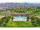 Aerial view of pool and recreation center with covered ramada in a community park with beautiful desert landscaping at 412 Gracious Way, Henderson, NV 89011