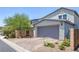 Two car gray garage exterior featuring a driveway and desert landscaping at 412 Gracious Way, Henderson, NV 89011