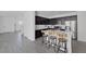 Modern kitchen featuring a large island with seating, stainless steel appliances, and dark wood cabinetry at 412 Gracious Way, Henderson, NV 89011