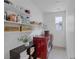 Functional laundry room with red washer/dryer and ample shelving at 412 Gracious Way, Henderson, NV 89011