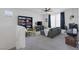 Cozy living room with a comfortable sofa, TV, bookshelf, ceiling fan, and convenient workspace at 412 Gracious Way, Henderson, NV 89011