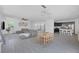 Bright open-concept living room and kitchen features a large sectional couch, dining table, and a modern kitchen with stainless steel appliances at 412 Gracious Way, Henderson, NV 89011