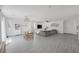 Spacious living area with a comfortable gray sectional couch, wooden dining table, and lots of natural light at 412 Gracious Way, Henderson, NV 89011