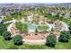 Aerial view of community playground with climbing features, grassy area, trees and lush landscaping at 412 Gracious Way, Henderson, NV 89011