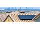 Close-up view of a tile roof with a solar panel against a scenic cityscape backdrop at 412 Gracious Way, Henderson, NV 89011