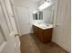 Bathroom featuring a double sink vanity, large mirror, and adjacent doorways at 4126 Jessica Marie St, North Las Vegas, NV 89032