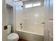 Bright bathroom features a shower-over-tub combo with white tile surround and a window for natural light at 4126 Jessica Marie St, North Las Vegas, NV 89032
