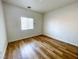 Bedroom with wood-look flooring and one window bringing in natural light at 4126 Jessica Marie St, North Las Vegas, NV 89032
