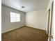 Simple bedroom with a large window, carpeted floor, and natural light at 4126 Jessica Marie St, North Las Vegas, NV 89032
