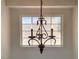Close-up of a chandelier hanging over a bright window at 4126 Jessica Marie St, North Las Vegas, NV 89032