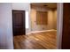 Inviting entryway with wood-look floors, a decorative window shade, and a dark wood front door at 4126 Jessica Marie St, North Las Vegas, NV 89032