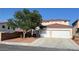 Charming two-story home featuring a red tile roof, complemented by a dual-door garage and landscaped front yard at 4126 Jessica Marie St, North Las Vegas, NV 89032