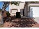 Well-maintained front yard featuring decorative gravel landscaping and a small tree, with a secure front door at 4126 Jessica Marie St, North Las Vegas, NV 89032