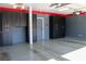 View of a garage features epoxy flooring, black cabinets, and overhead lighting, offering ample storage at 4126 Jessica Marie St, North Las Vegas, NV 89032