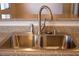 Stainless steel kitchen sink with sprayer and soap dispenser, set in granite countertops at 4126 Jessica Marie St, North Las Vegas, NV 89032