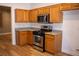 Well-equipped kitchen featuring stainless steel appliances, granite countertops, and warm wood cabinets at 4126 Jessica Marie St, North Las Vegas, NV 89032