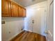 Small laundry room with overhead cabinets and wood-look flooring at 4126 Jessica Marie St, North Las Vegas, NV 89032