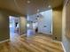 Open concept living room featuring wood-look floors and seamless access to the kitchen and staircase at 4126 Jessica Marie St, North Las Vegas, NV 89032
