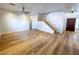 Large living room features wood-look flooring, staircase, and a dark-stained entry door at 4126 Jessica Marie St, North Las Vegas, NV 89032