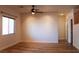Open-concept living area with wood-look floors, ceiling fan and a view of the staircase at 4126 Jessica Marie St, North Las Vegas, NV 89032
